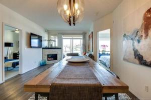 a large living room with a large wooden table at Tranquil Waterfront Condo in Kelowna