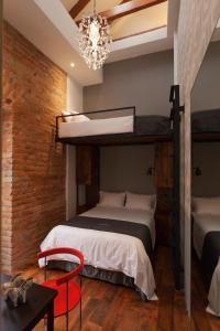 Voodi või voodid majutusasutuse Carlota Sustainable Design Hotel toas