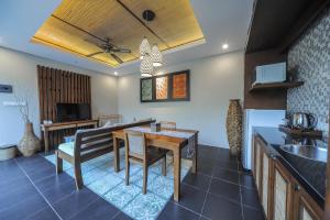 a kitchen and dining room with a table and chairs at Gaing Mas Jimbaran Villas by Gaing Mas Group in Jimbaran