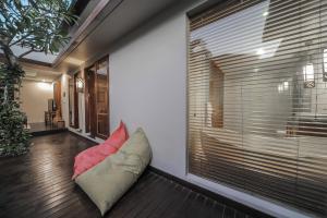 a room with a pillow sitting on the floor next to a window at Gaing Mas Jimbaran Villas by Gaing Mas Group in Jimbaran