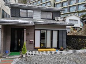 una casa con un banco amarillo delante de ella en 宝栄 villas lakeside, en Fujikawaguchiko