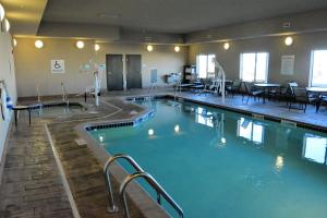 a large swimming pool in a hotel room at Holiday Inn Express & Suites Glendive, an IHG Hotel in Glendive