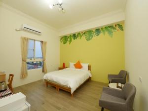 Posteľ alebo postele v izbe v ubytovaní Hengchun Inn