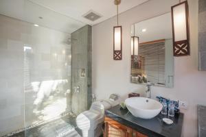 a bathroom with a toilet and a sink and a shower at Gaing Mas Jimbaran Villas by Gaing Mas Group in Jimbaran