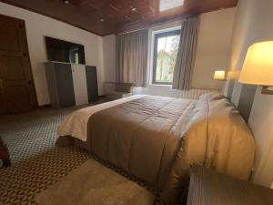 a bedroom with a large bed and a window at El Niu de l’Àguila (Camprodon) in Camprodon +42 photos