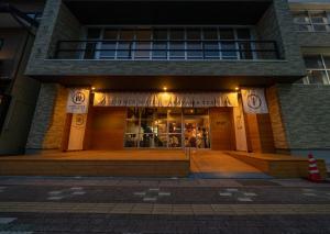 a store front of a building at night at Residence Hotel Takayama Station in Takayama
