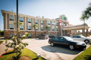 a car parked in a parking lot in front of a building at Holiday Inn Express Hotel & Suites Houston NW Beltway 8-West Road by IHG in Houston