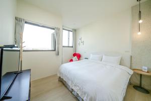 En eller flere senger på et rom på 宜蘭-讀好民宿 Read Nice House B&B 電梯民宿