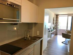 a kitchen with a sink and a counter top at Appartement _An der Seebruecke_ in Glücksburg