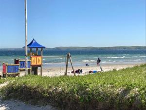 a playground on a beach next to the ocean at Ferienwohnung Torge in Glücksburg