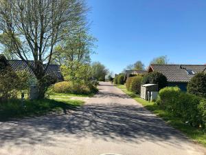 a road in a village with houses and trees at Ferienwohnung Torge in Glücksburg