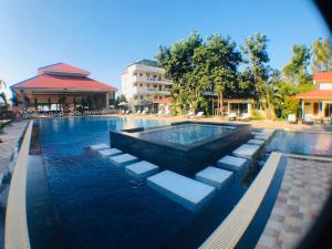 a swimming pool with blue water in a resort at New Travel Beach Hotel & Resort in Chao Lao Beach