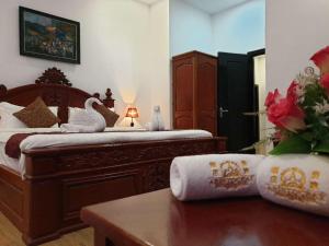 Ein Bett oder Betten in einem Zimmer der Unterkunft Aristocrat Residence & Hotel
