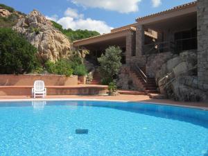 a swimming pool in front of a house at Casa Rosa Arancio in Costa Paradiso +17 photos