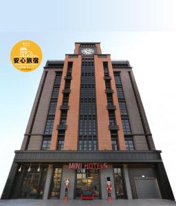 un edificio alto con un reloj encima en MINI HOTELS (Feng Jia Branch) en Taichung