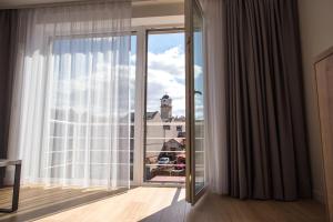 a room with a window with a view of a city at City apartment Poprad in Poprad