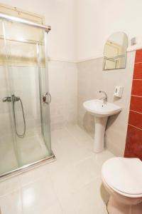 a bathroom with a shower and a toilet and a sink at Levanten Hostel in Istanbul