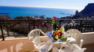 a table with a plate of fruit on a balcony at Апартаменти Свети Георги - Saint George Apartments in Kavarna