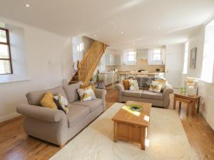 a living room with two couches and a table at The Chapel in Redcar