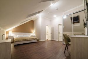 a bedroom with a bed and a sink in a room at ROSSI HOTEL in Tver