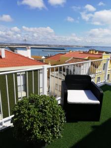 a couch on a balcony with a view of the ocean at West Coast Peniche in Peniche