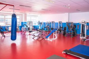 a fitness room with a gym with machines and a punching bag at Tamsalu Spordikompleksi Hostel in Tamsalu