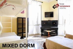 a room with a bed and a television at Rome Experience Hostel in Rome