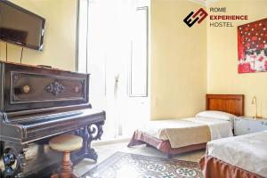 a bedroom with a piano and a bed at Rome Experience Hostel in Rome