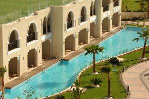 an aerial view of a building with a swimming pool at Sunrise Arabian Beach Resort in Sharm El Sheikh