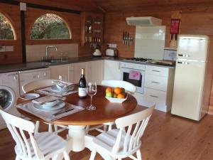 a kitchen with a table with a bottle of wine at Treetops in Parracombe