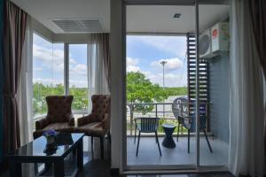 a living room with a view of a balcony at The River Scene in Krabi