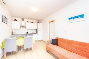 a living room with a couch and a table at Apartments Peco in Korčula