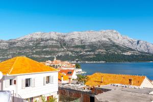 a view of a town with a mountain in the background at Apartments Peco in Korčula