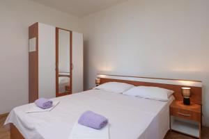 Postel nebo postele na pokoji v ubytování Beach Apartments "Bili Cvitak"