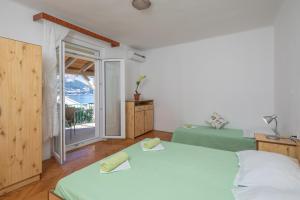 Postel nebo postele na pokoji v ubytování Beach Apartments "Bili Cvitak"