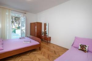 Postel nebo postele na pokoji v ubytování Beach Apartments "Bili Cvitak"