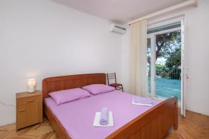 Postel nebo postele na pokoji v ubytování Beach Apartments "Bili Cvitak"