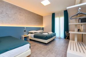 a hotel room with two beds and a window at Garda Diamant in Desenzano del Garda