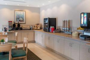 a kitchen with a sink and a counter top at La Quinta by Wyndham Fort Myers Airport in Fort Myers