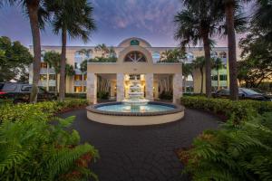 a large building with a fountain in front of it at La Quinta I-95 Deerfield Beach - Next to The Home Depot & Behind The Wawa in Deerfield Beach