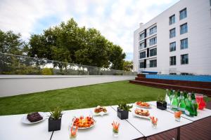 a table with food and drinks on a balcony at Lux Fatima Park - Hotel, Suites & Residence in Fátima