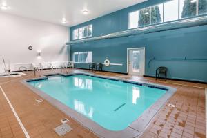 a large swimming pool with blue water in a room at Sleep Inn near Washington State Line in Post Falls
