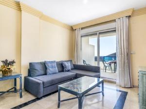 a living room with a couch and a glass table at Apartamento 306 in Marbella