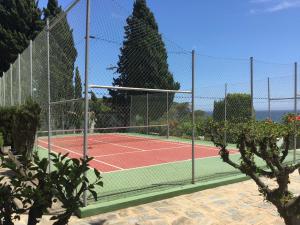 a tennis court with a net on a tennis court at Macdonald Leila Playa Resort in La Cala de Mijas
