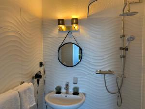 a bathroom with a sink and a mirror at Boutique Hotel Villa Sarah in Düsseldorf