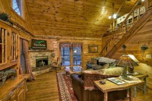 a living room with a couch and a fireplace in a log cabin at Big Buck Lodge in Blue Ridge