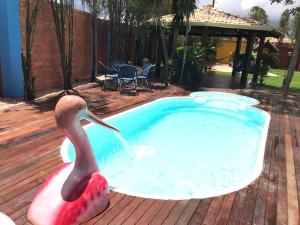 a statue of a flamingo in a swimming pool at RC HOUSE in Chapada dos Guimarães