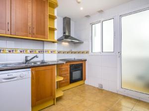 a kitchen with wooden cabinets and a sink at Apartamento 329 in Marbella
