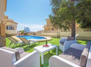 a patio with chairs and a table and a pool at Villa Silene - Plusholidays in Calpe