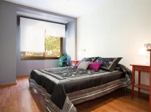 a bedroom with a large bed in a room at GAUDI Barcelonastuff Apartments in Barcelona